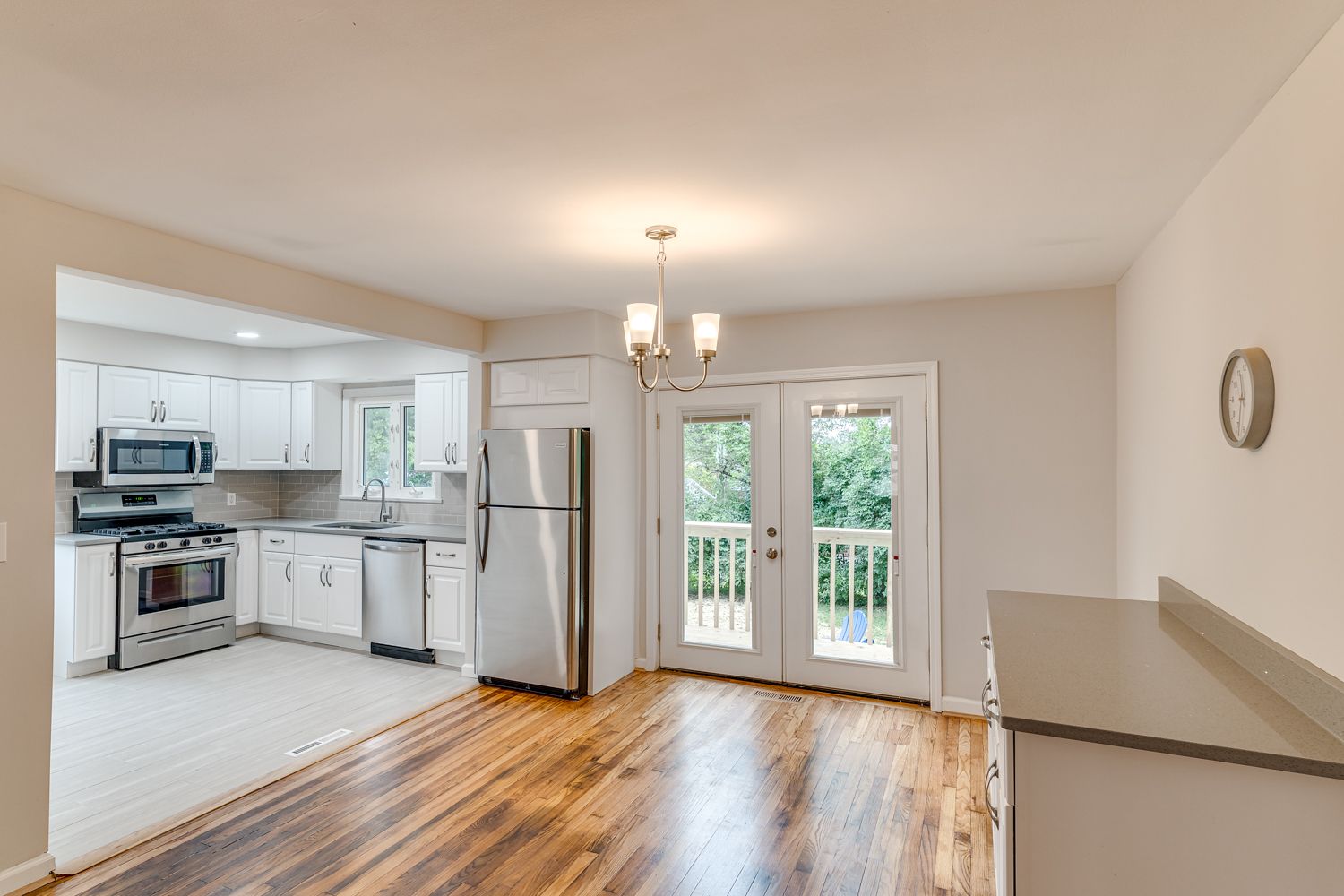 Renovated cottage kitchen and dining area with French doors to the backyard