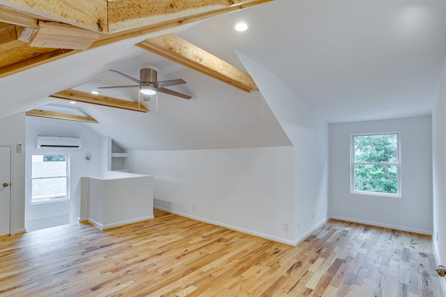Finished attic suite with vaulted ceiling, beams, and mini-split