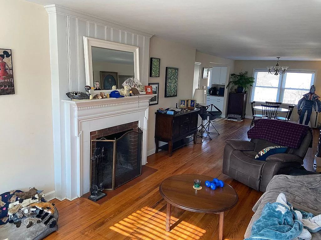 Occupied living room with fireplace before renovation