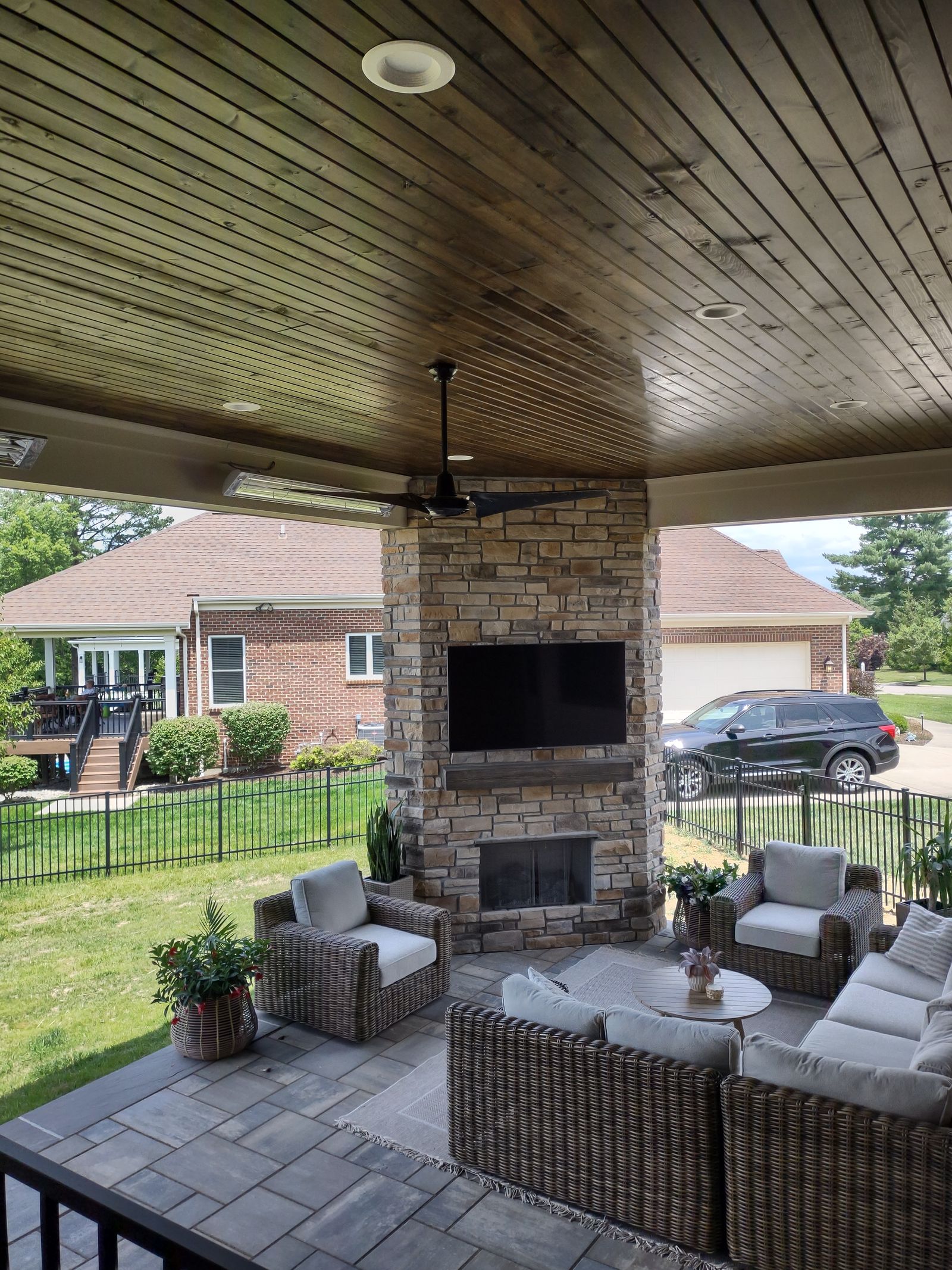 Fire feature anchoring a covered porch lounge