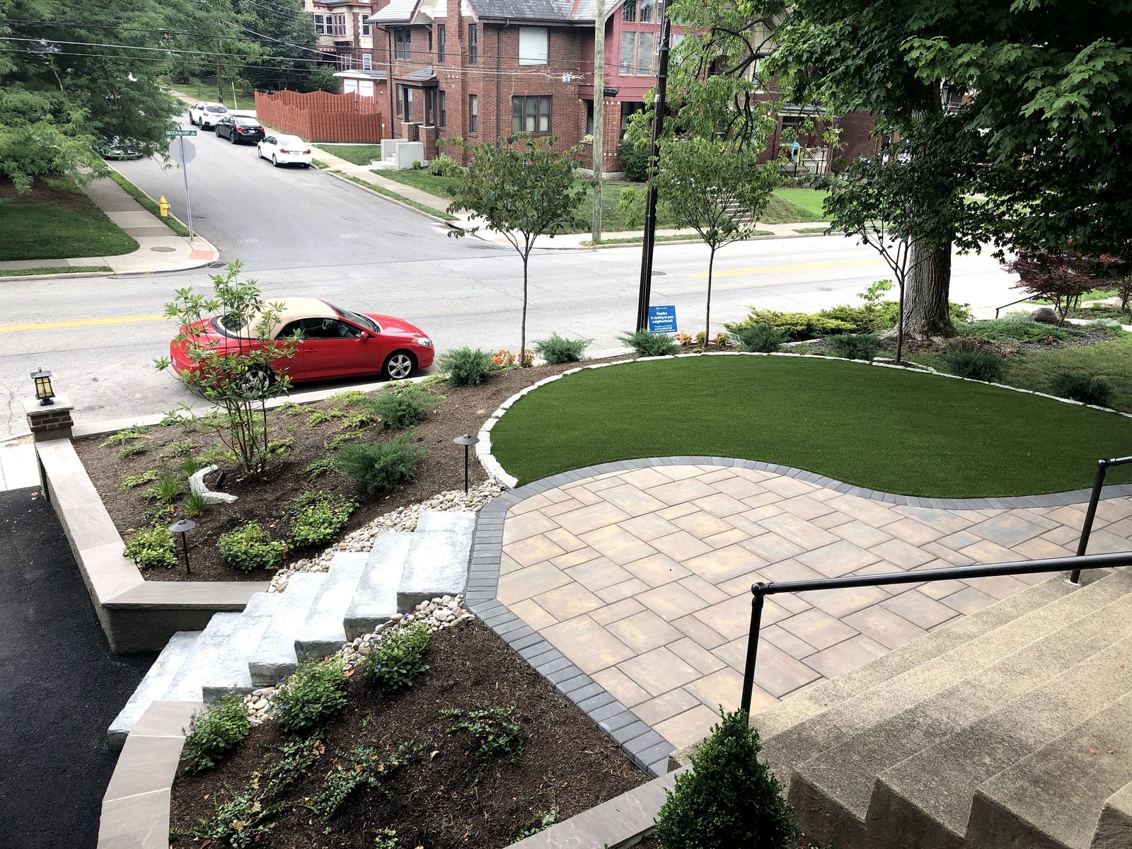 Paver driveway with a curved layout and landscaped borders