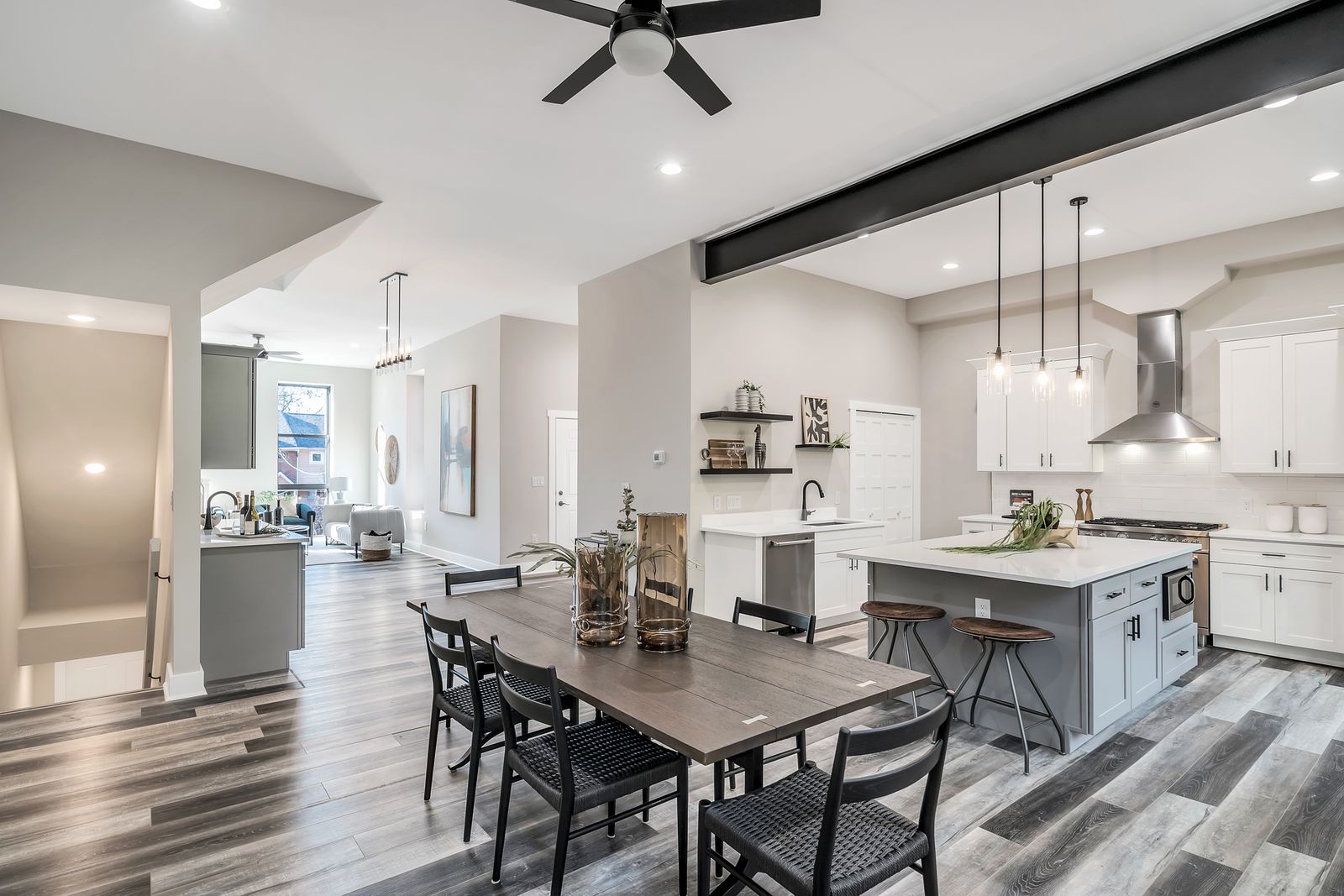 Renovated kitchen and dining room with exposed steel beam and arched windows
