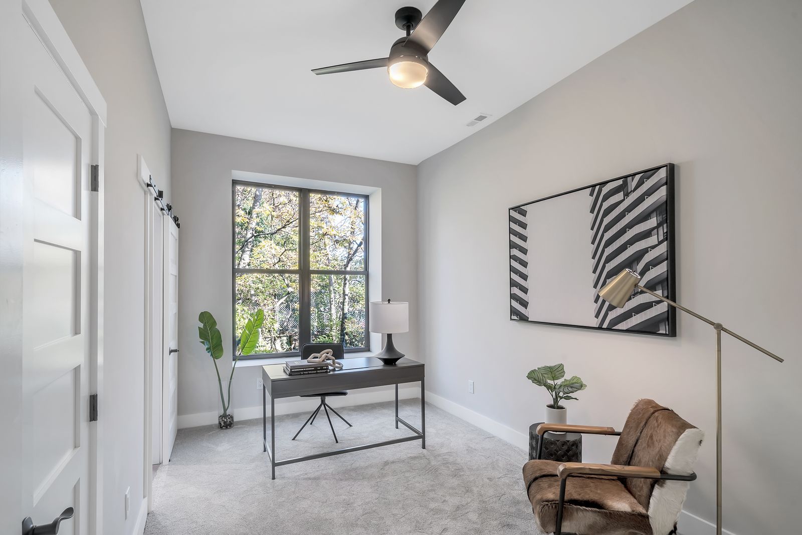 Home office with garden-facing windows and vaulted ceiling