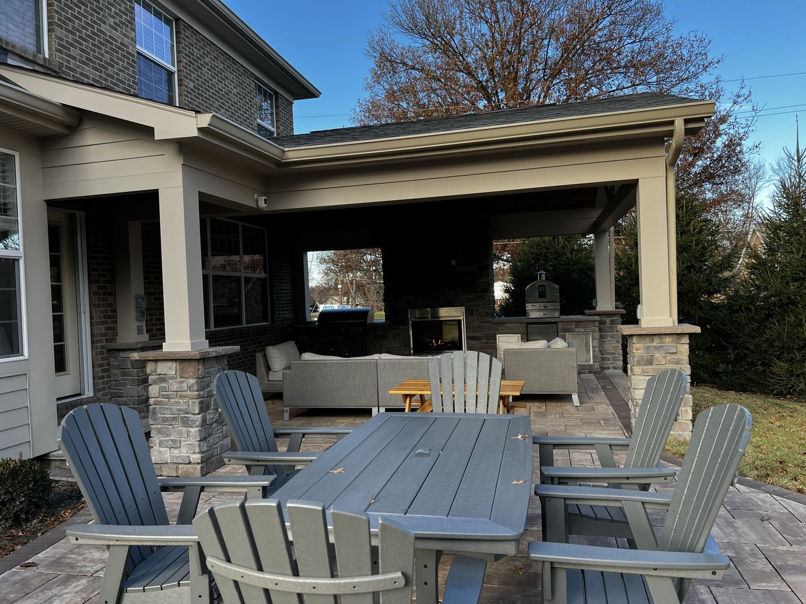 Outdoor kitchen and living room under a covered structure