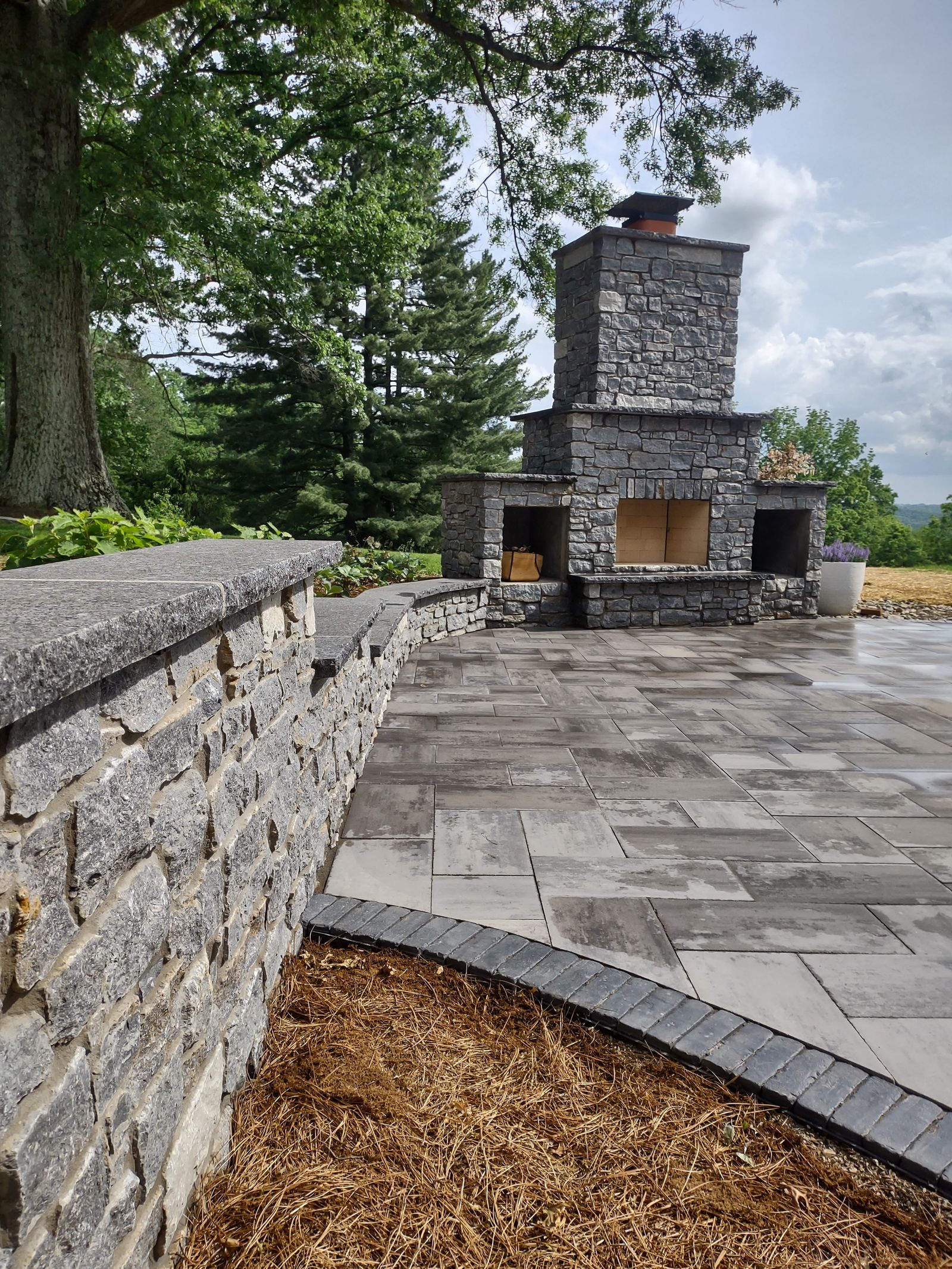 Fire feature and seating wall on a custom paver patio