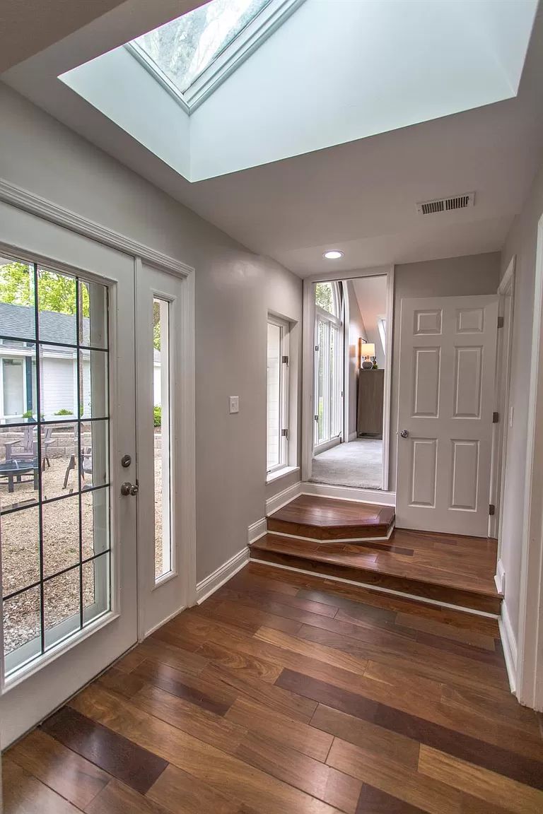 Entry hall with skylight and refinished hardwood floors