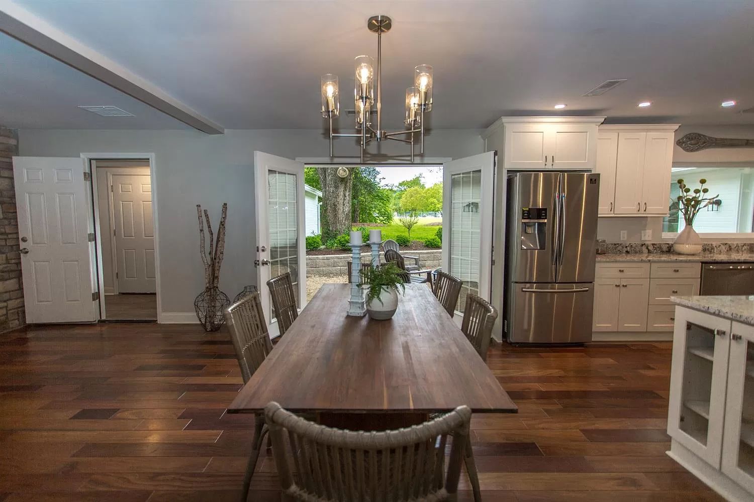 Dining room with chandelier opening to the kitchen