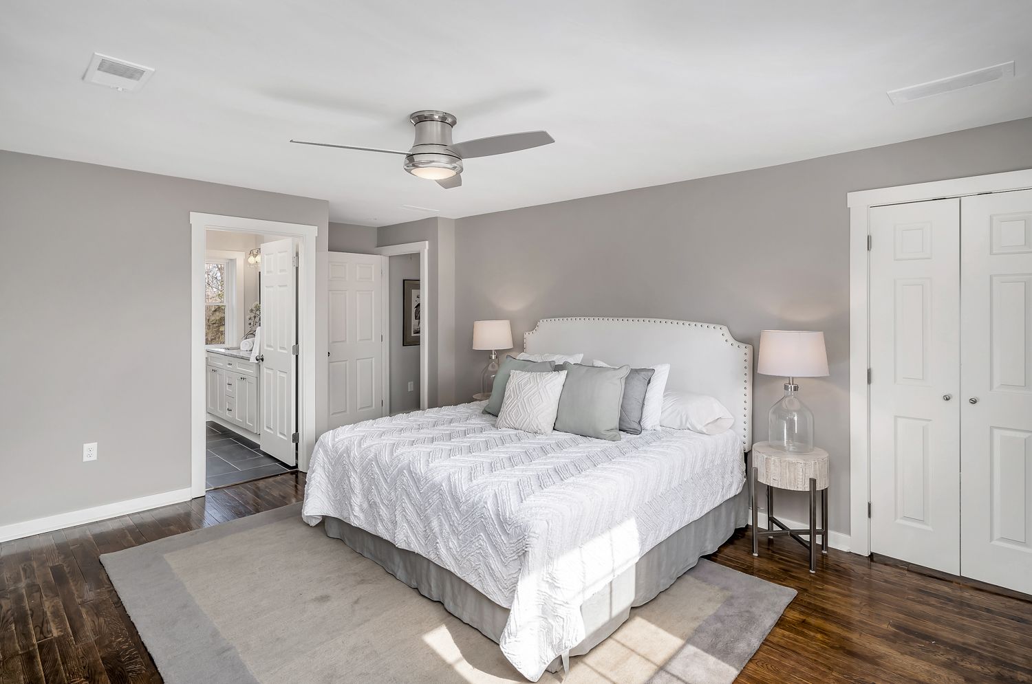 Renovated bedroom with ceiling fan and hardwood floors