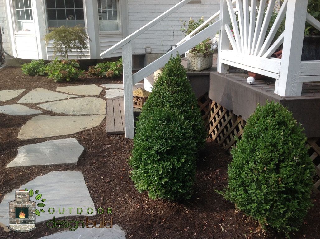 Irregular flagstone path through mulch and shrubs