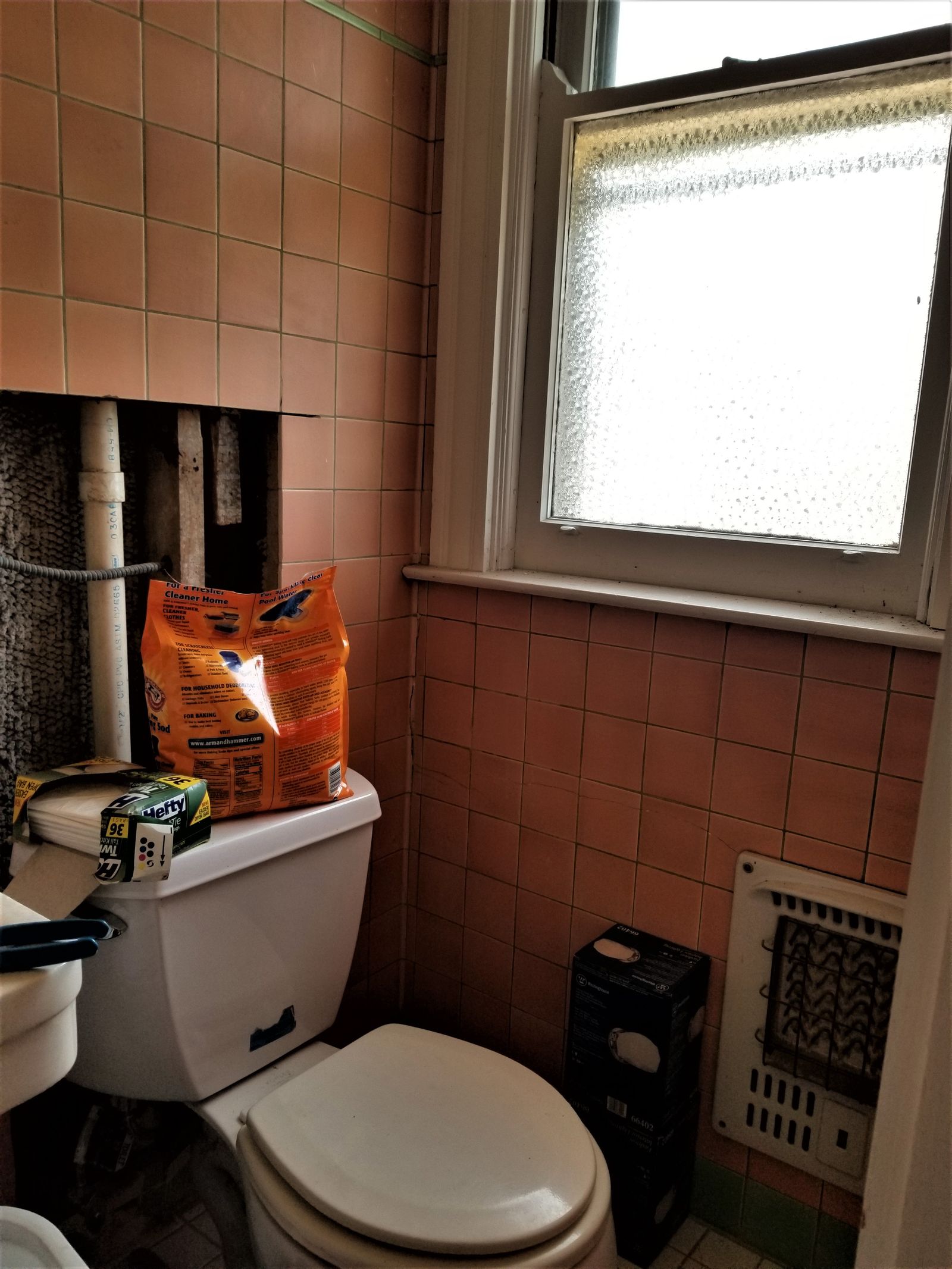 Dated pink-tile bathroom before renovation