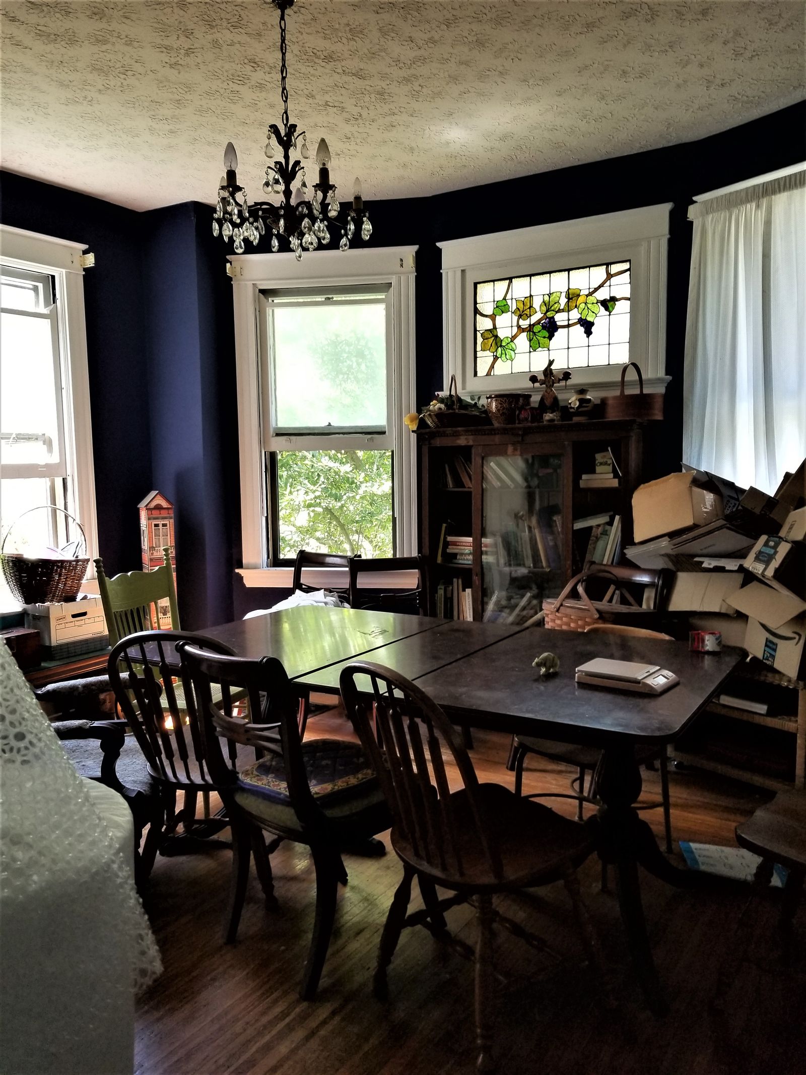 Dark cluttered dining room before renovation